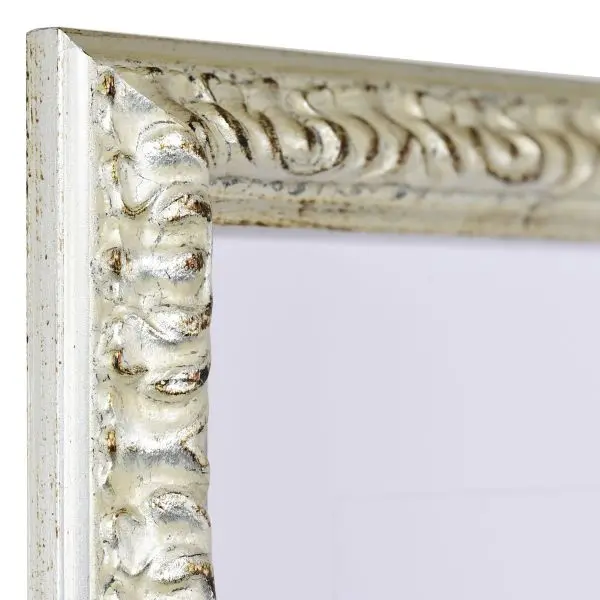 Vista de la esquina de un marco de madera barroco plateado, ricamente adornado con ornamentación floral