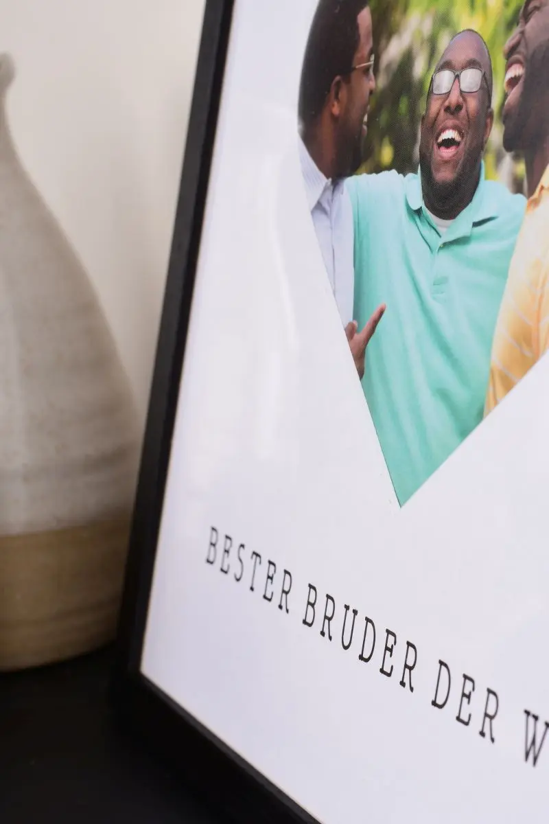 Primer plano de un marco de fotos de 30x30 en negro con un recorte de corazón para el mejor hermano del mundo.